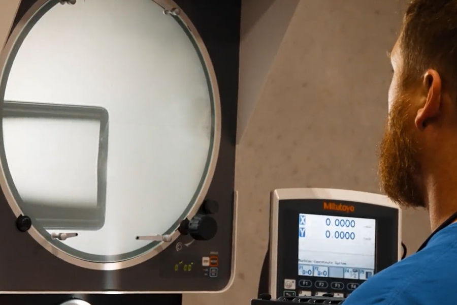 Optical comparator inspecting a vial